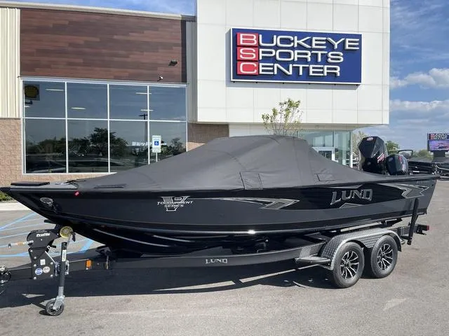 Slide: The Image of 2025 Lund 2075 Pro-V Sport boat at Buckeye Sports Center, covered and on a trailer. - 1