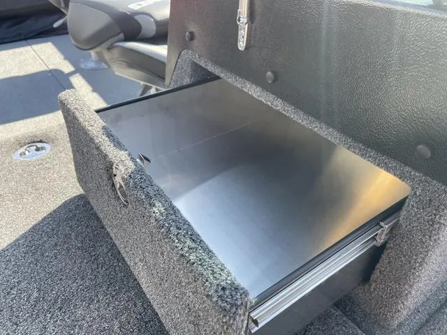 Slide: The Image of 2025 Lund 2075 Pro-V Sport boat interior storage compartment with open drawer. - 13