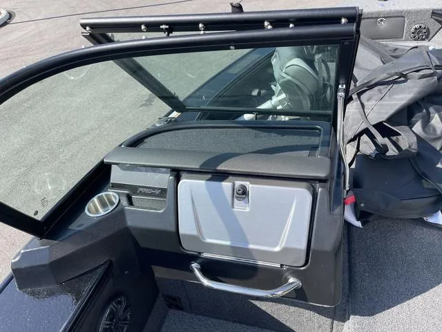 Slide: The Image of 2025 Lund 2075 Pro-V Sport boat interior with windshield and storage compartment. - 17