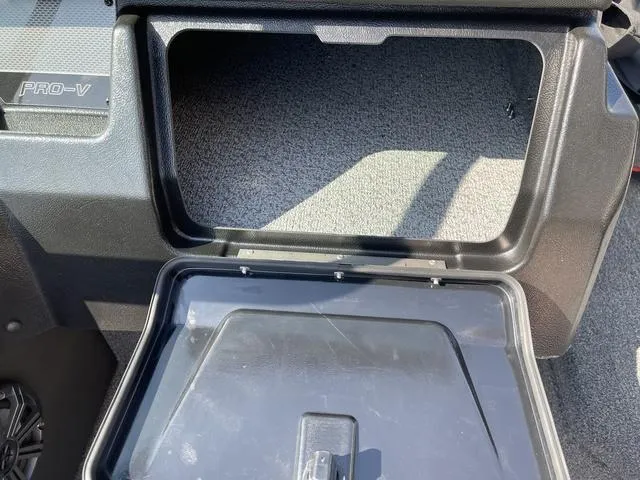 Slide: The Image of Open storage compartment in 2025 Lund 2075 Pro-V Sport boat. - 18