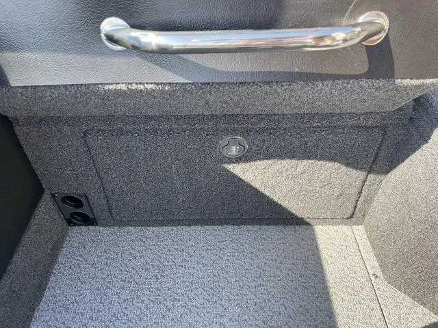 Slide: The Image of 2025 Lund 2075 Pro-V Sport interior storage compartment with handle and textured finish. - 19