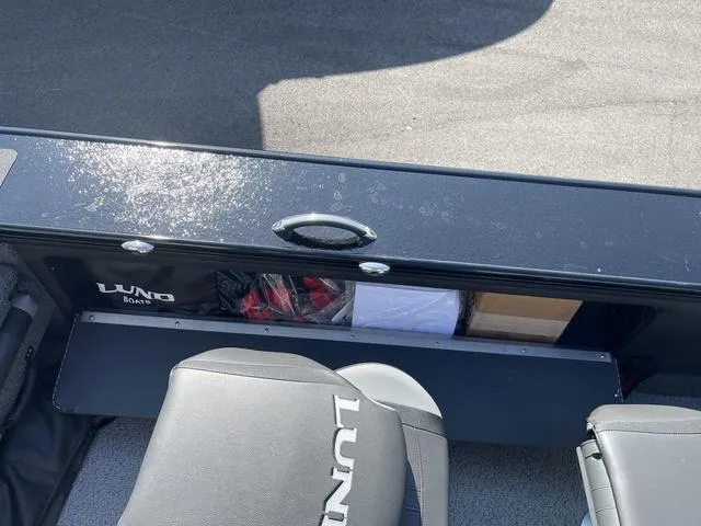 Slide: The Image of 2025 Lund 2075 Pro-V Sport boat interior with storage compartment and seats. - 22