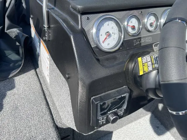 Slide: The Image of Dashboard of 2025 Lund 2075 Pro-V Sport boat with gauges and steering wheel. - 24