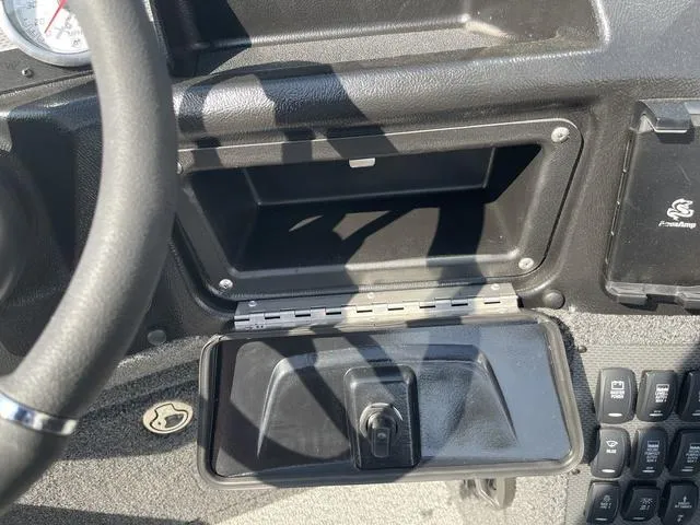 Slide: The Image of Dashboard of 2025 Lund 2075 Pro-V Sport boat with open storage compartment. - 25