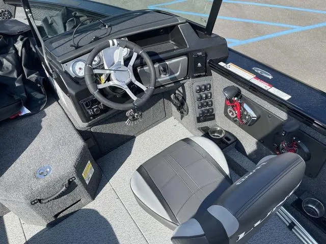 Slide: The Image of 2025 Lund 2075 Pro-V Sport boat interior with steering wheel and seating. - 29