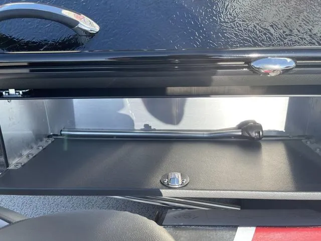 Slide: The Image of 2025 Lund 2075 Pro-V Sport boat storage compartment with sleek black interior. - 31