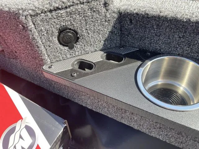 Slide: The Image of 2025 Lund 2075 Pro-V Sport boat interior with cup holder and power outlet. - 32