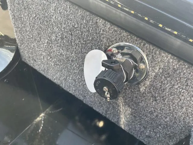 Slide: The Image of Key ignition switch on 2025 Lund 2075 Pro-V Sport boat dashboard. - 33
