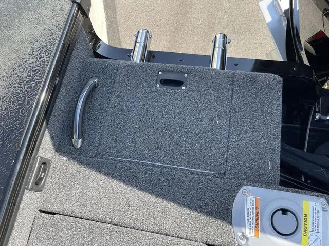 Slide: The Image of 2025 Lund 2075 Pro-V Sport boat deck with storage compartment and handle. - 35