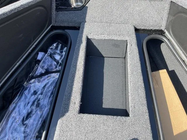 Slide: The Image of 2025 Lund 2075 Pro-V Sport boat storage compartments with carpeted interior. - 36