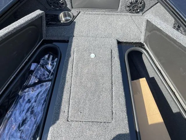 Slide: The Image of 2025 Lund 2075 Pro-V Sport boat interior with storage compartments and speakers. - 37