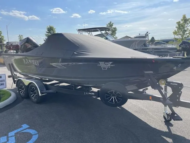 Slide: The Image of 2025 Lund 2075 Pro-V Sport boat on trailer, covered, parked outdoors. - 4