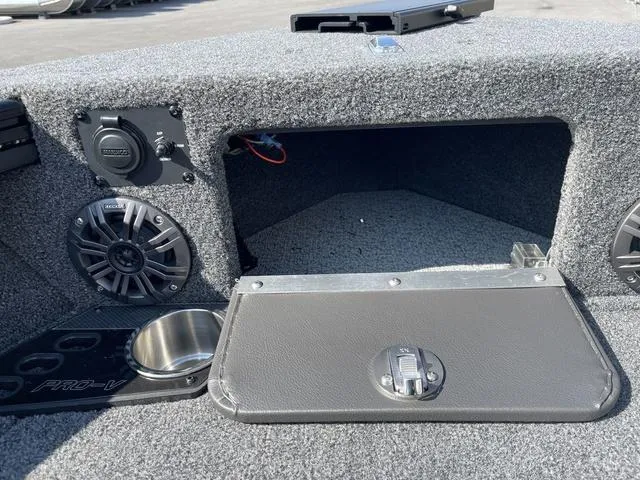 Slide: The Image of 2025 Lund 2075 Pro-V Sport boat interior with storage compartment and speakers. - 40