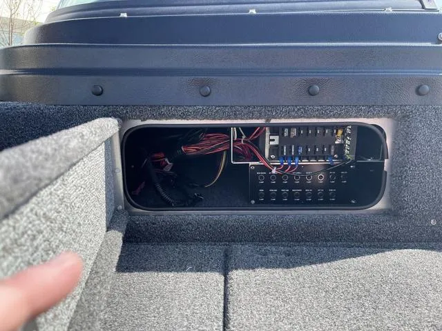 Slide: The Image of 2025 Lund 2075 Pro-V Sport boat electrical panel with wiring and switches. - 42