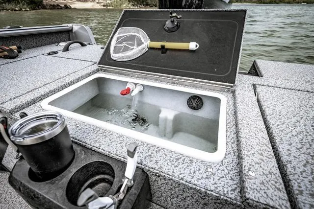 Slide: The Image of 2025 Lund 1775 Impact XS Sport boat with open livewell and fishing gear. - 10