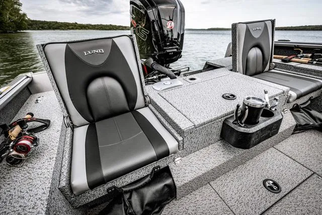 Slide: The Image of 2025 Lund 1775 Impact XS Sport boat interior with comfortable seating and fishing gear. - 11