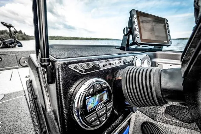 Slide: The Image of 2025 Lund 1775 Impact XS Sport dashboard with Lowrance GPS and control panel. - 5