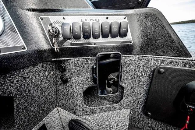 Slide: The Image of 2025 Lund 1775 Impact XS Sport dashboard with control panel and smartphone holder. - 6