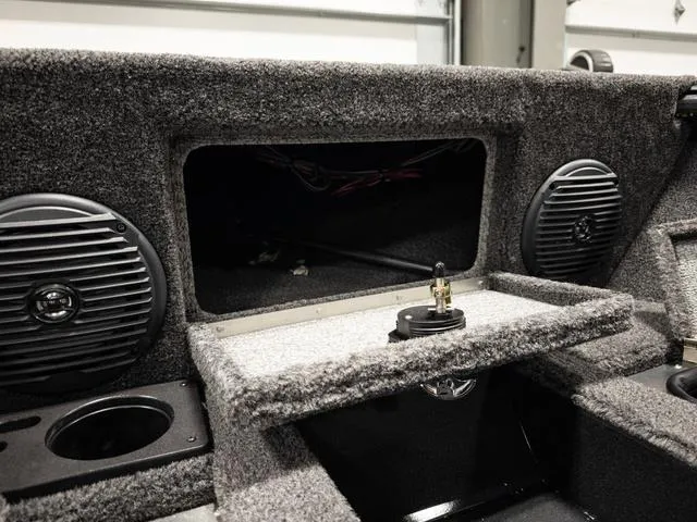 Slide: The Image of 2025 Lund 1875 Impact XS boat interior with speakers and storage compartment. - 18