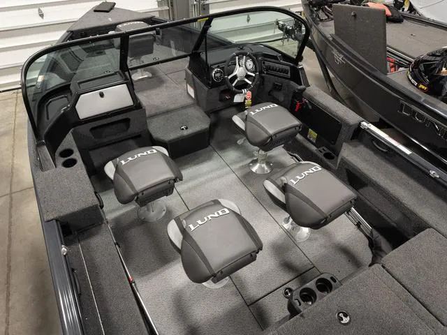 Slide: The Image of 2025 Lund 1875 Impact XS boat interior with fishing rod storage and steering wheel. - 3