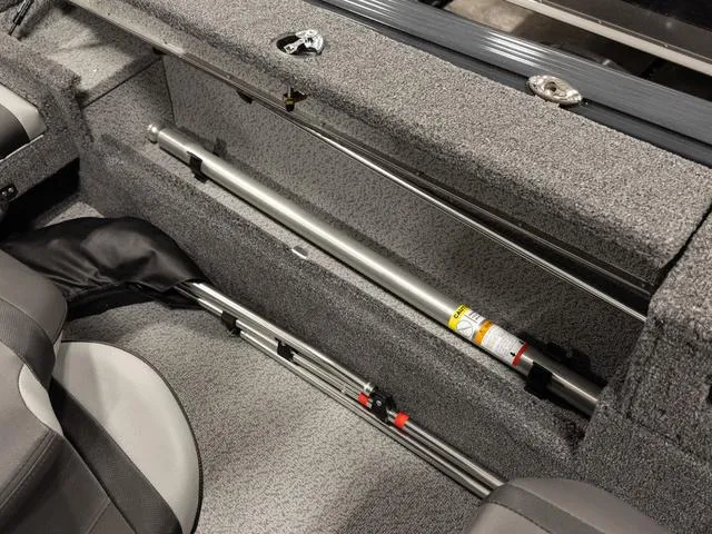 Slide: The Image of 2025 Lund 1875 Impact XS boat interior with rod storage, on calm water. - 6