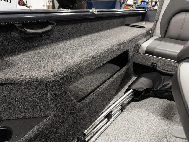 Slide: The Image of Person organizing tackle box in 2025 Lund 1875 Impact XS boat storage compartment. - 7