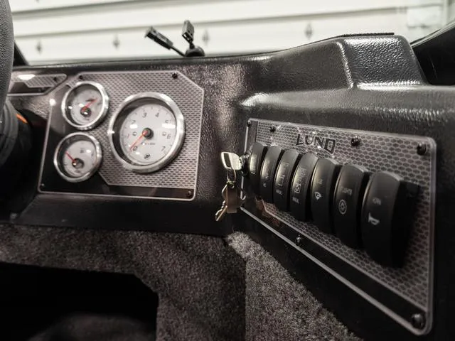 Slide: The Image of Dashboard of 2025 Lund 1875 Impact XS boat with gauges and control switches. - 9