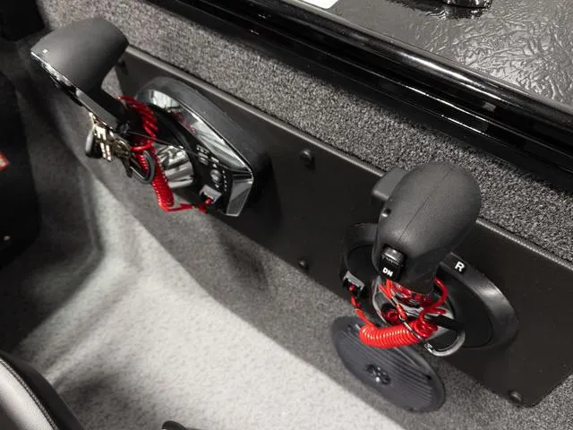 Slide: The Image of 2025 Lund 2075 Fisherman Sport boat controls with red safety lanyards. - 14
