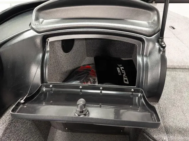 Slide: The Image of 2025 Lund 2075 Fisherman Sport boat storage compartment with open lid. - 19