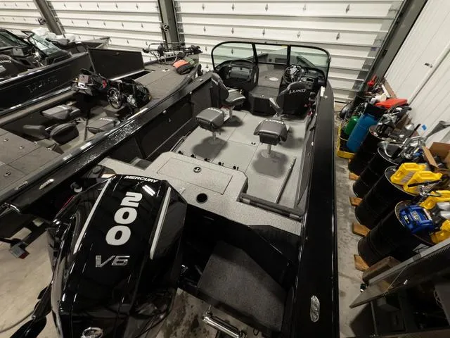 Slide: The Image of 2025 Lund 2075 Fisherman Sport boat on calm lake water. - 2