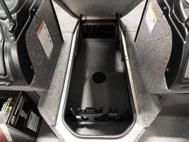 Slide: The Image of Interior storage compartment of 2025 Lund 2075 Fisherman Sport boat, featuring carpeted finish. - 21