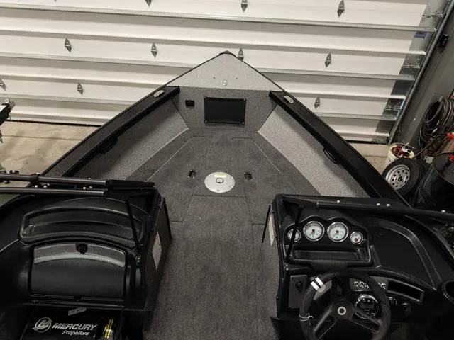 Slide: The Image of 2025 Lund 2075 Fisherman Sport boat interior with dashboard and carpeted deck. - 22