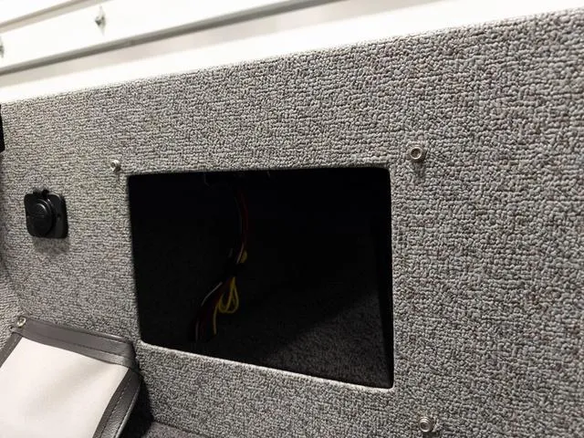 Slide: The Image of 2025 Lund 2075 Fisherman Sport interior compartment with wiring visible. - 24