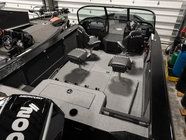 Slide: The Image of 2025 Lund 2075 Fisherman Sport boat interior with seating and navigation equipment. - 3