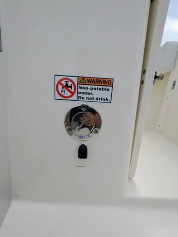 Slide: The Image of 2025 Cobia 220 CC boat interior with rod holders and seating. - 13