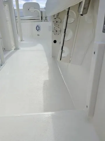 Slide: The Image of 2025 Cobia 220 CC boat interior with cup holders and spacious deck. - 14