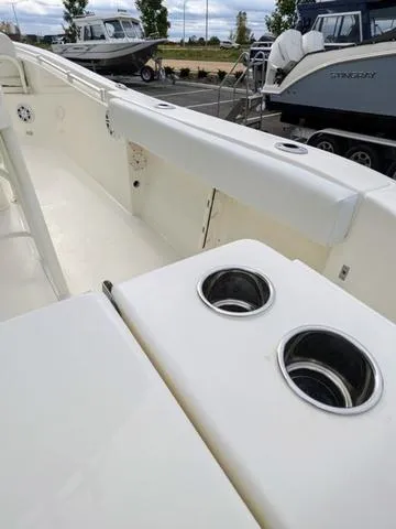 Slide: The Image of 2025 Cobia 220 CC boat console with seating and controls. - 15