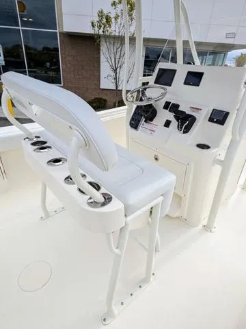 Slide: The Image of 2025 Cobia 220 CC boat deck with seating and storage compartments. - 16