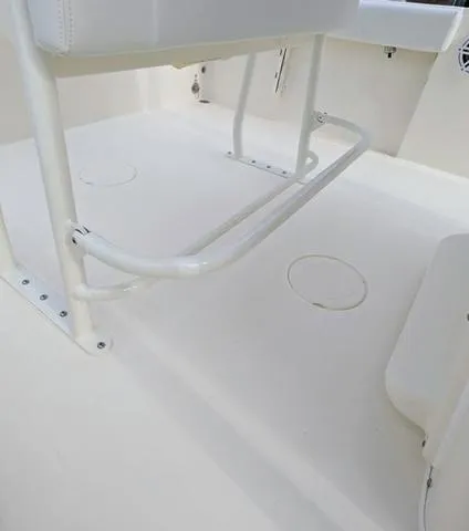 Slide: The Image of 2025 Cobia 220 CC boat seating with rod holders and white upholstery. - 17