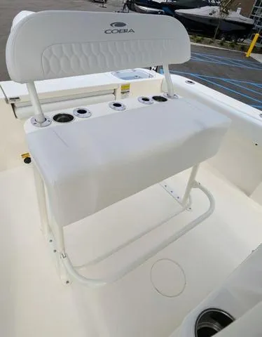 Slide: The Image of 2025 Cobia 220 CC boat dashboard with controls and audio system. - 18