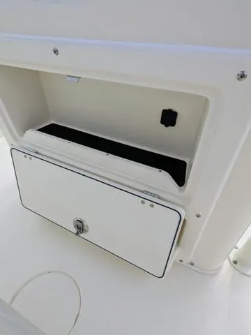 Slide: The Image of 2025 Cobia 220 CC boat dashboard with steering wheel and electronic displays. - 23