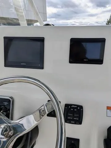 Slide: The Image of 2025 Cobia 220 CC boat speaker on white interior panel. - 24