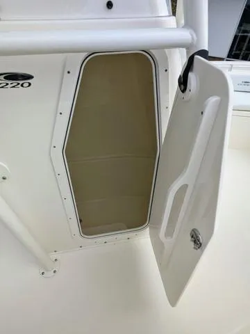 Slide: The Image of 2025 Cobia 220 CC boat storage compartment interior view. - 26