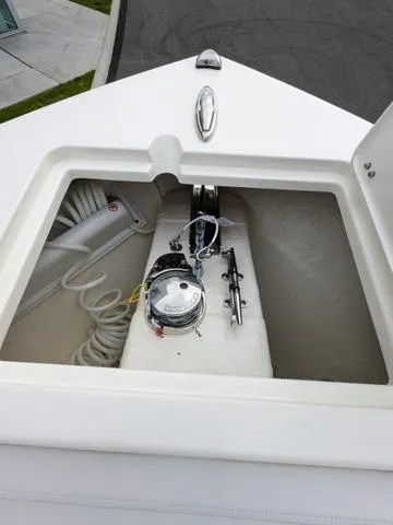 Slide: The Image of 2025 Cobia 220 CC boat interior with white seating and console. - 28