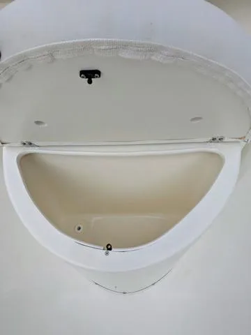 Slide: The Image of 2025 Cobia 220 CC boat interior with white seating and clean deck. - 30