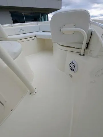Slide: The Image of 2025 Cobia 220 CC boat interior with cushioned seating and stainless steel railings. - 32