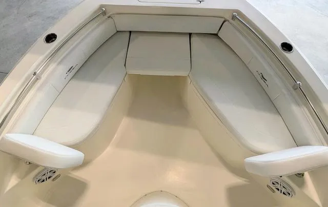 Slide: The Image of 2025 Cobia 220 CC boat interior with cushioned seating and speaker. - 33