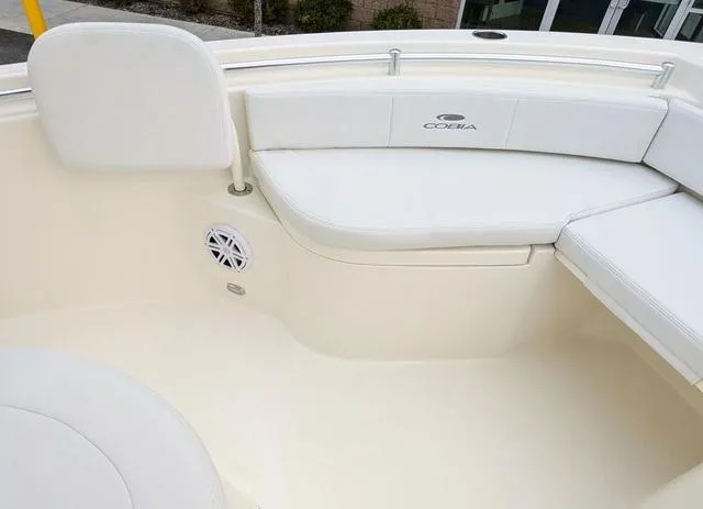 Slide: The Image of 2025 Cobia 220 CC storage compartment with white interior and black trim. - 35