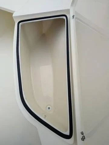 Slide: The Image of 2025 Cobia 220 CC boat interior with spacious seating and storage compartments. - 36