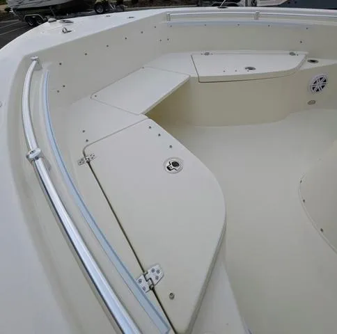 Slide: The Image of 2025 Cobia 220 CC boat deck with storage compartments and seating. - 37